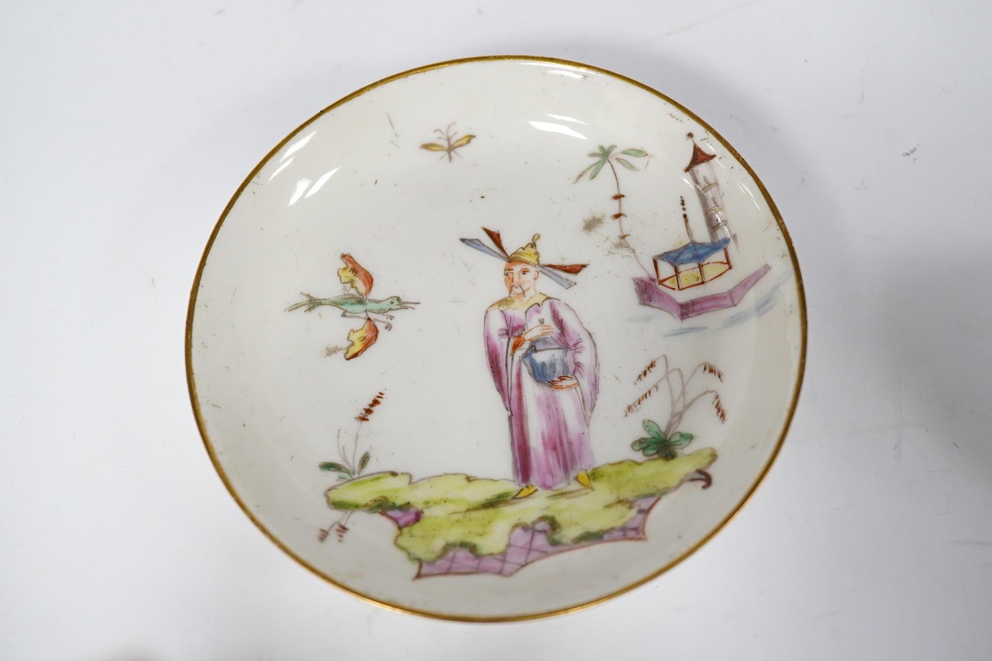 A Nove porcelain tea bowl and saucer, c.1770-75, hand painted with Chinese figures, iron red asterisk marks, 11.5cm in diameter